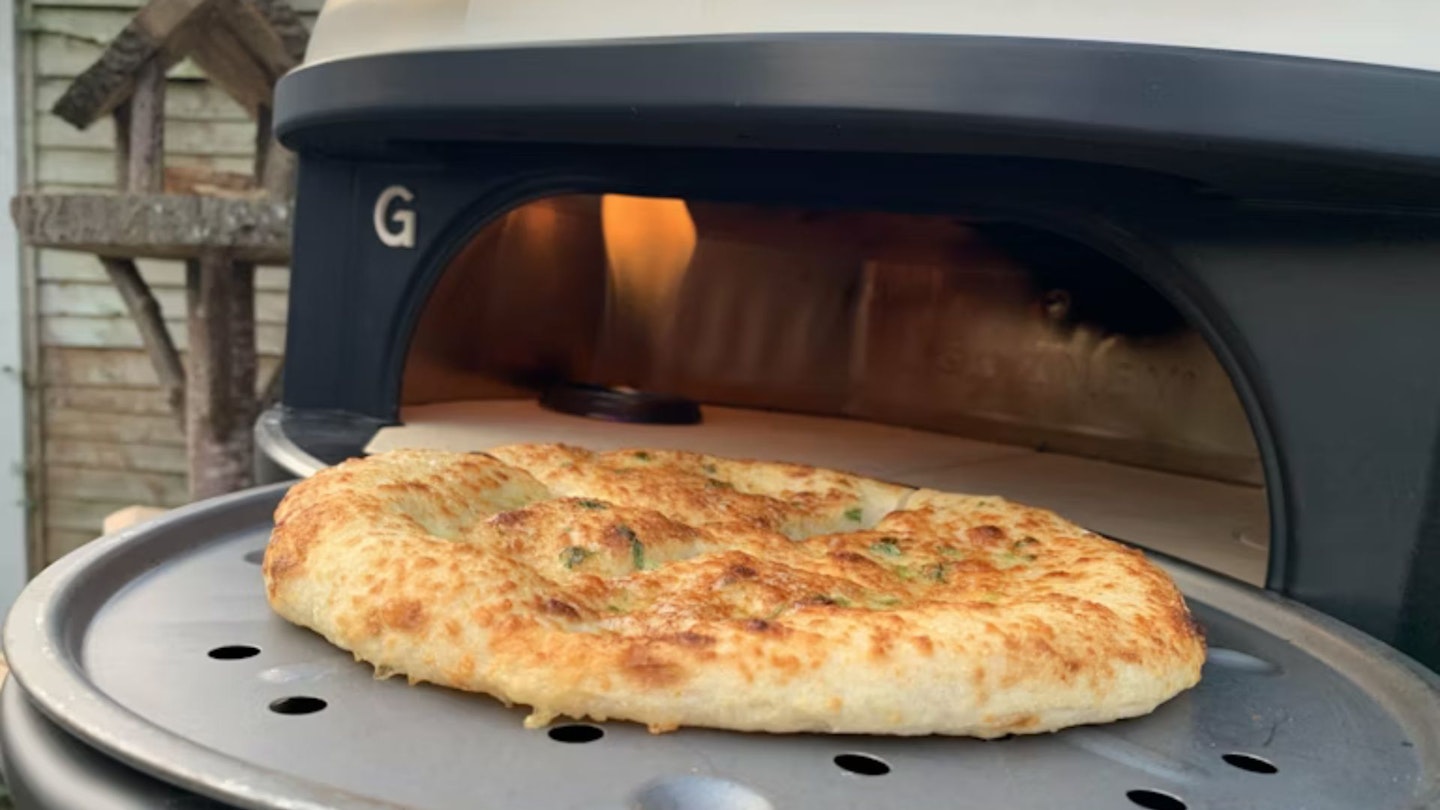Cheese pizza emerging from the Gozney pizza oven
