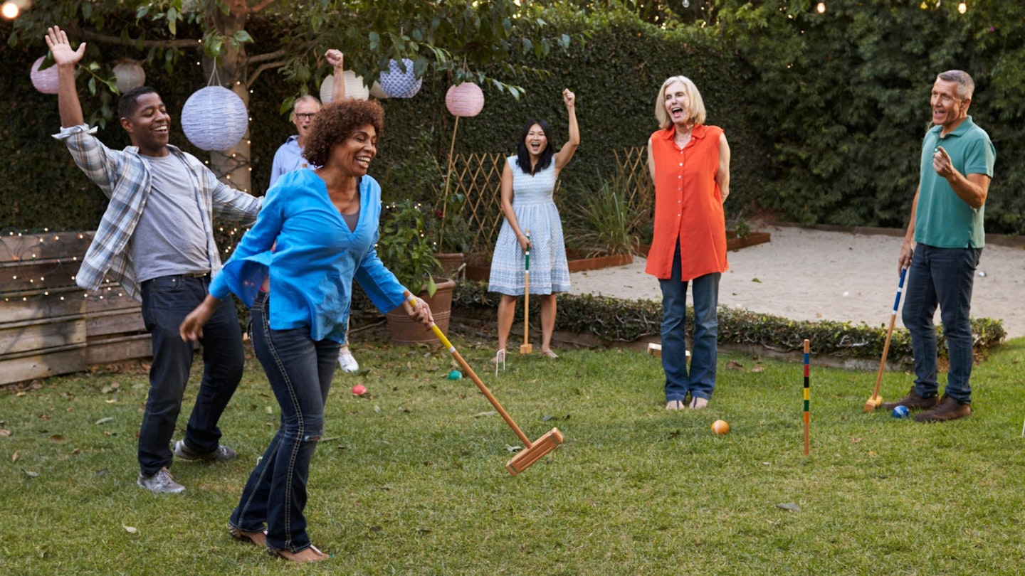 Group Of Mature Friends Playing Lawn Games For Adults