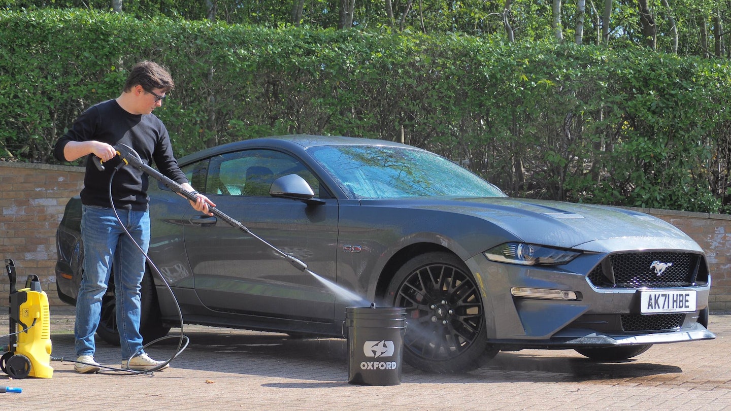 Cleaning a Ford Mustang with a pressure washer