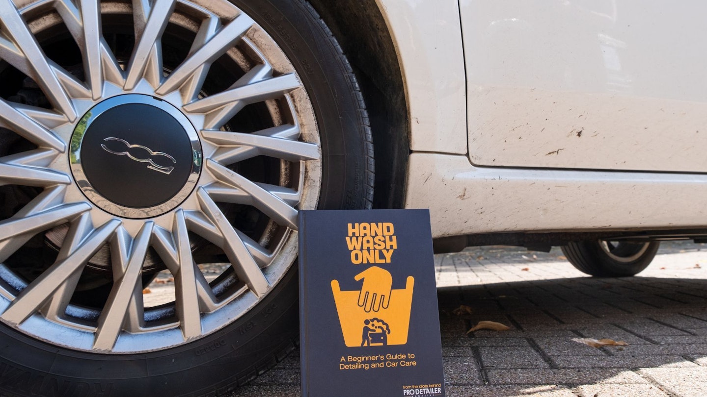 The Hand Wash Only book next to a car wheel