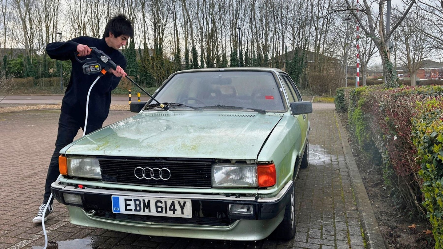 Aaron Hussain rinsing prewash off Audi