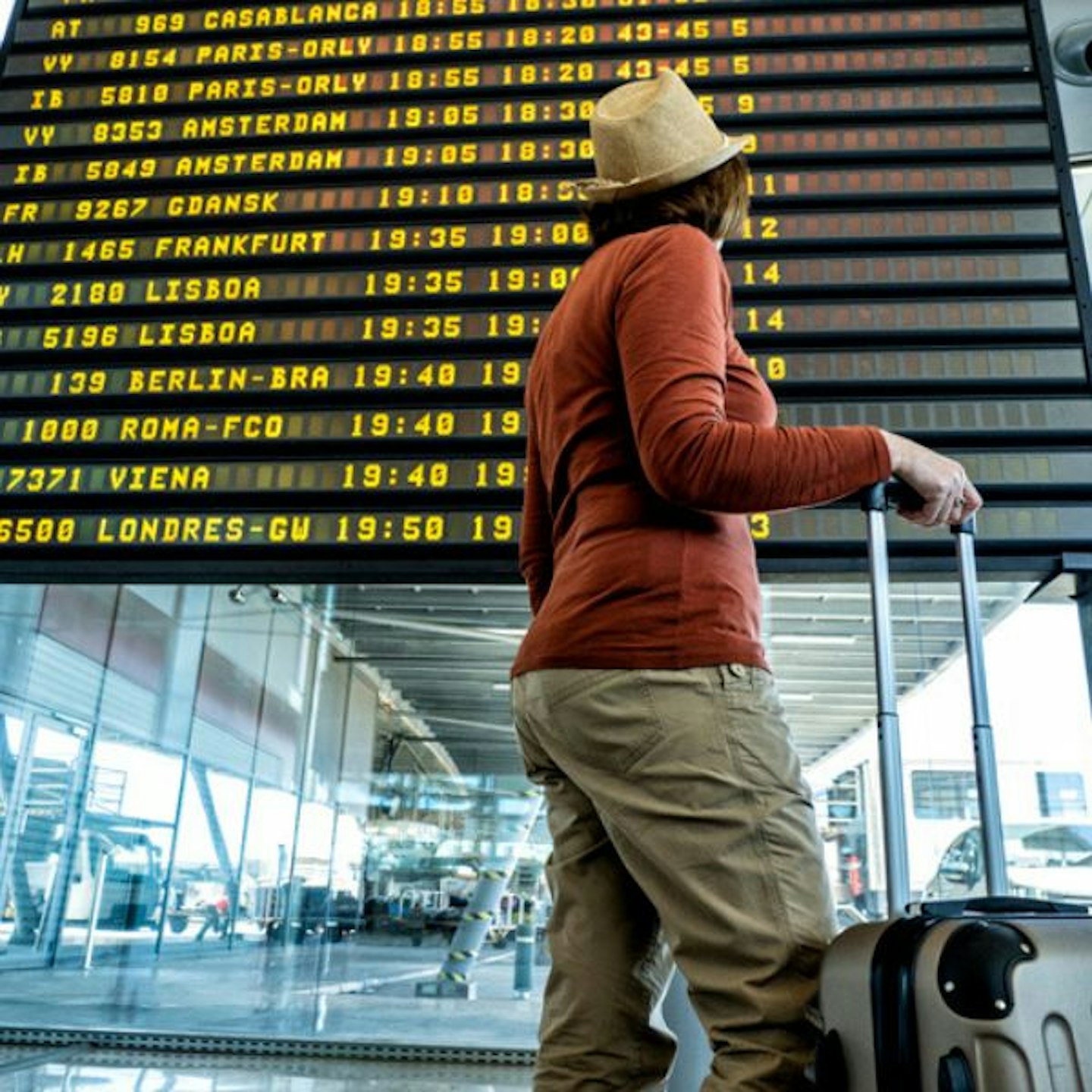 person standing in front of flight board