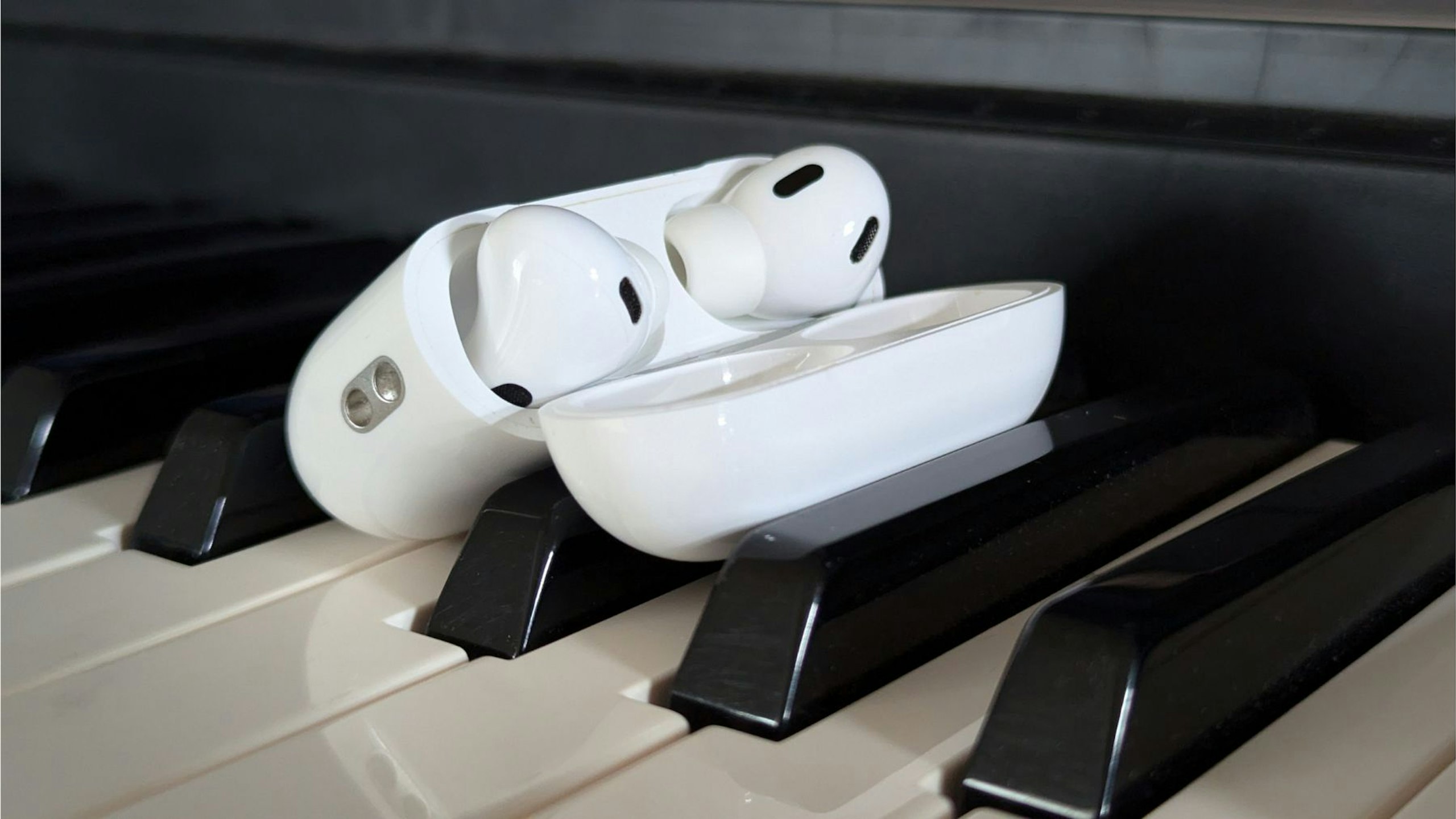 Apple AirPods Pro 2 true-wireless earphones on digital piano