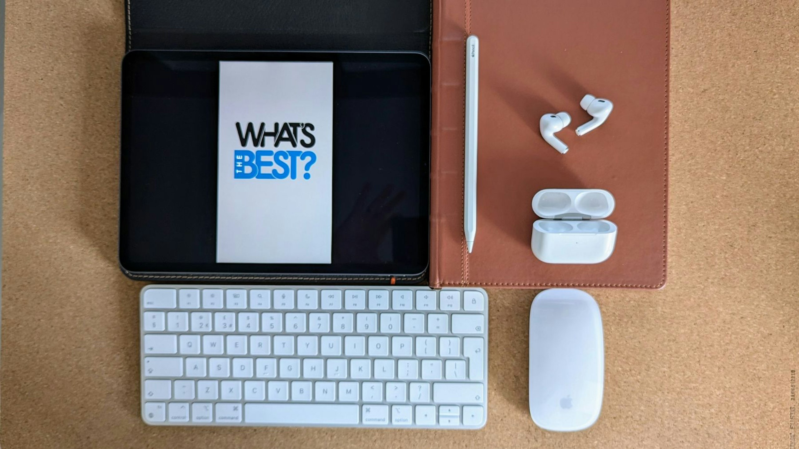 Apple AirPods Pro 2 - Apple's best wireless earbuds - on a desk mat alongside Apple Pencil, iPad, Magic Mouse and Magic Keyboard