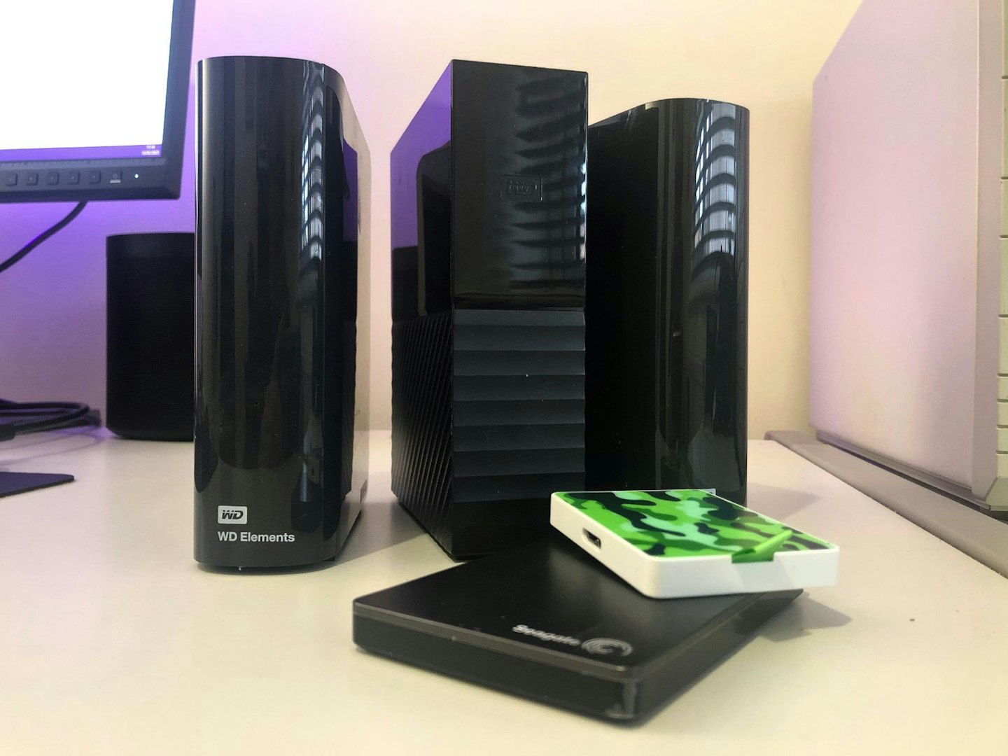 Some HDD and SSD external hard drives on a desk