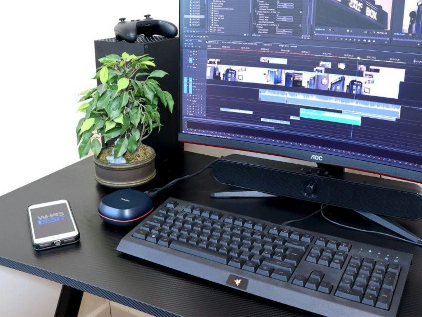 SanDisk Desk Drive SSD 8TB, External Desktop SSD on desk with phone, computer and pot plant.