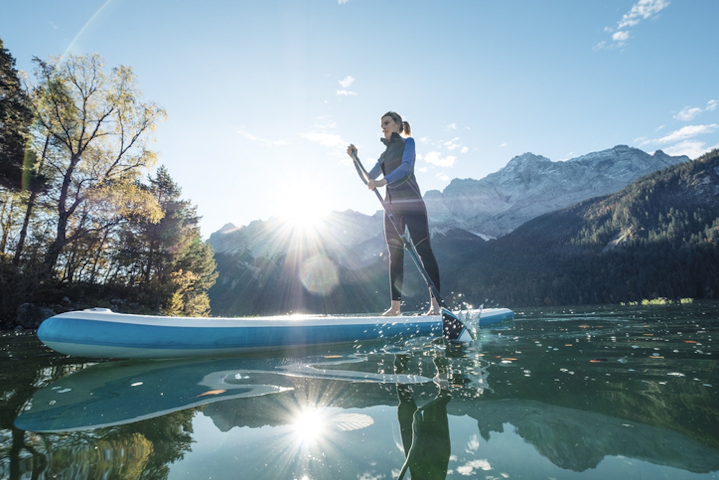 Young woman stand-up-paddling on lake