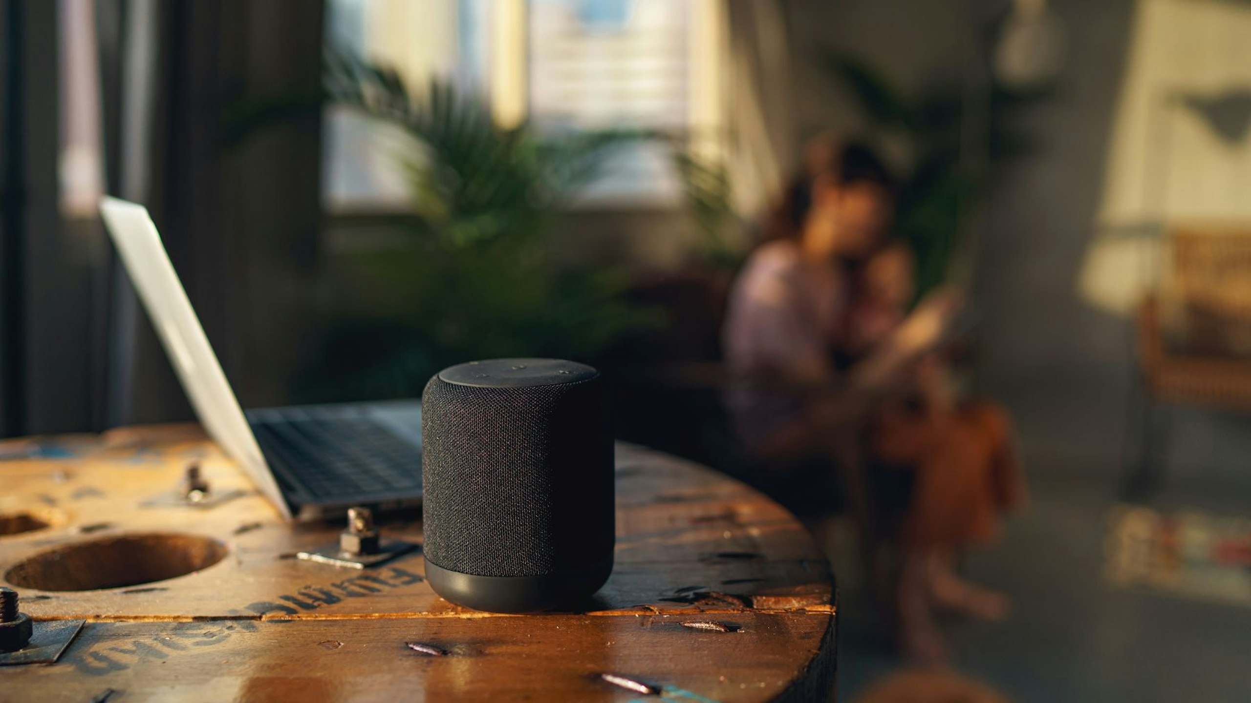 A smart speaker helping parents while they care for their child in a family home