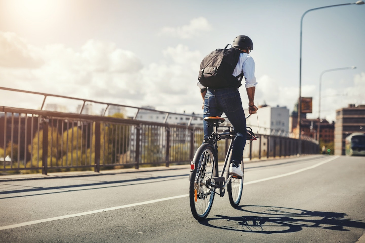 Man commuting on a bicycle with backpack on