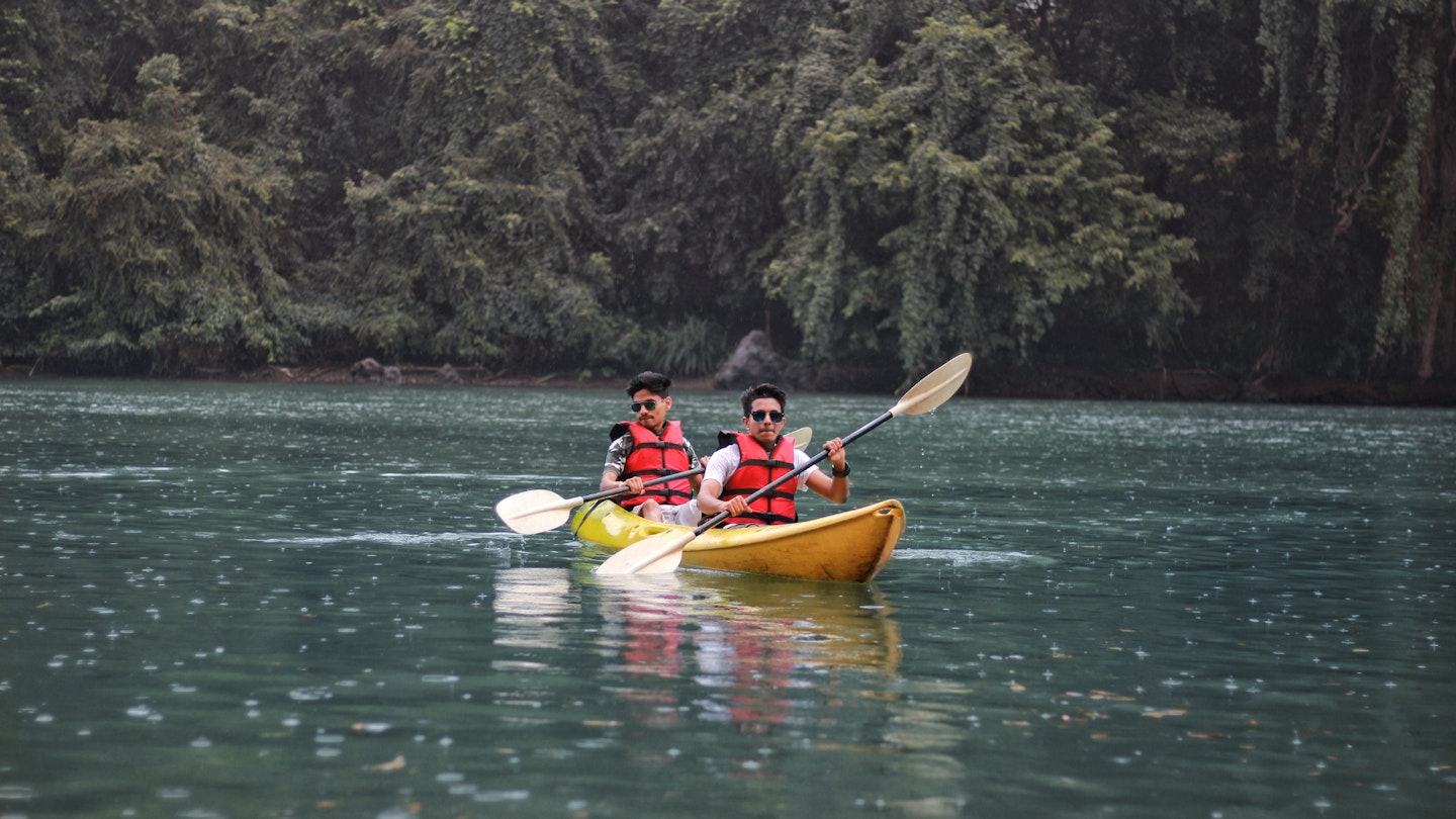 Two men paddling with inflatable kayak seats