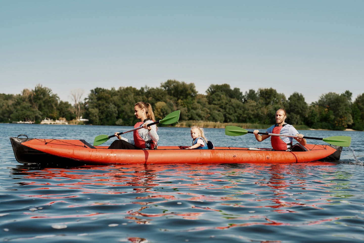 a family on one of the best three-person inflatable kayaks