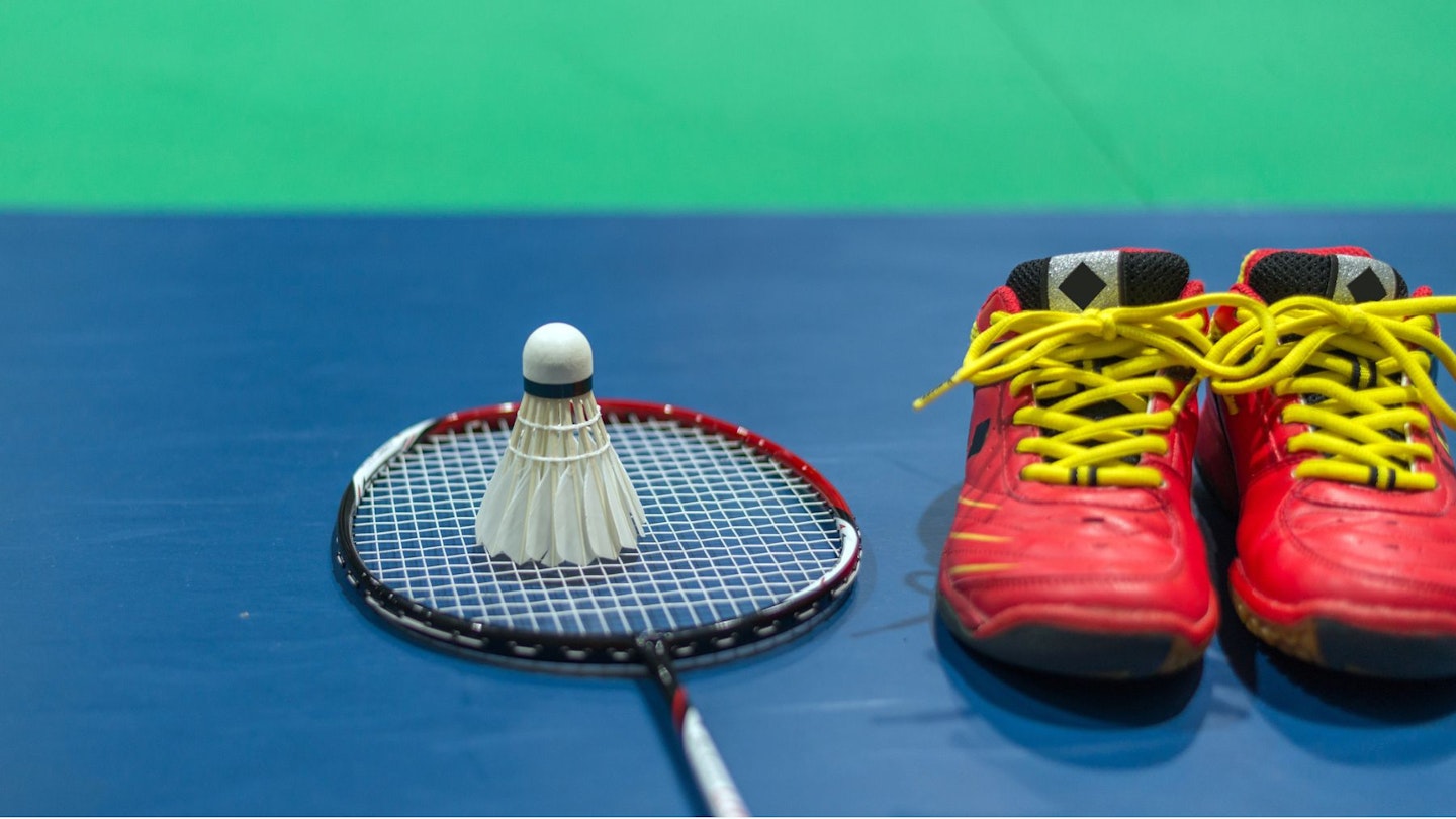 The best badminton shoes alongside badminton racquet and shuttlecock.