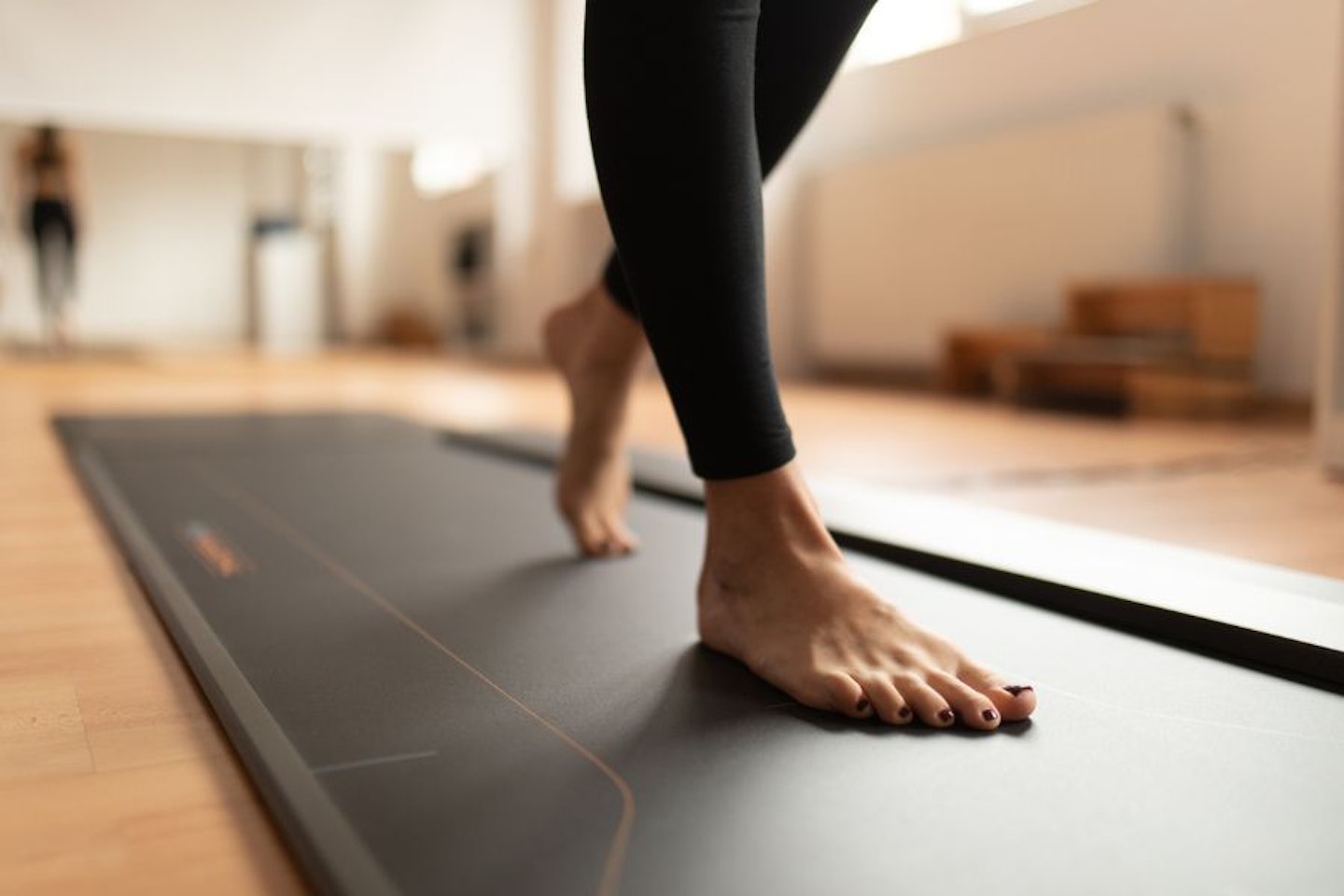 Woman walking on a treadmill barefoot