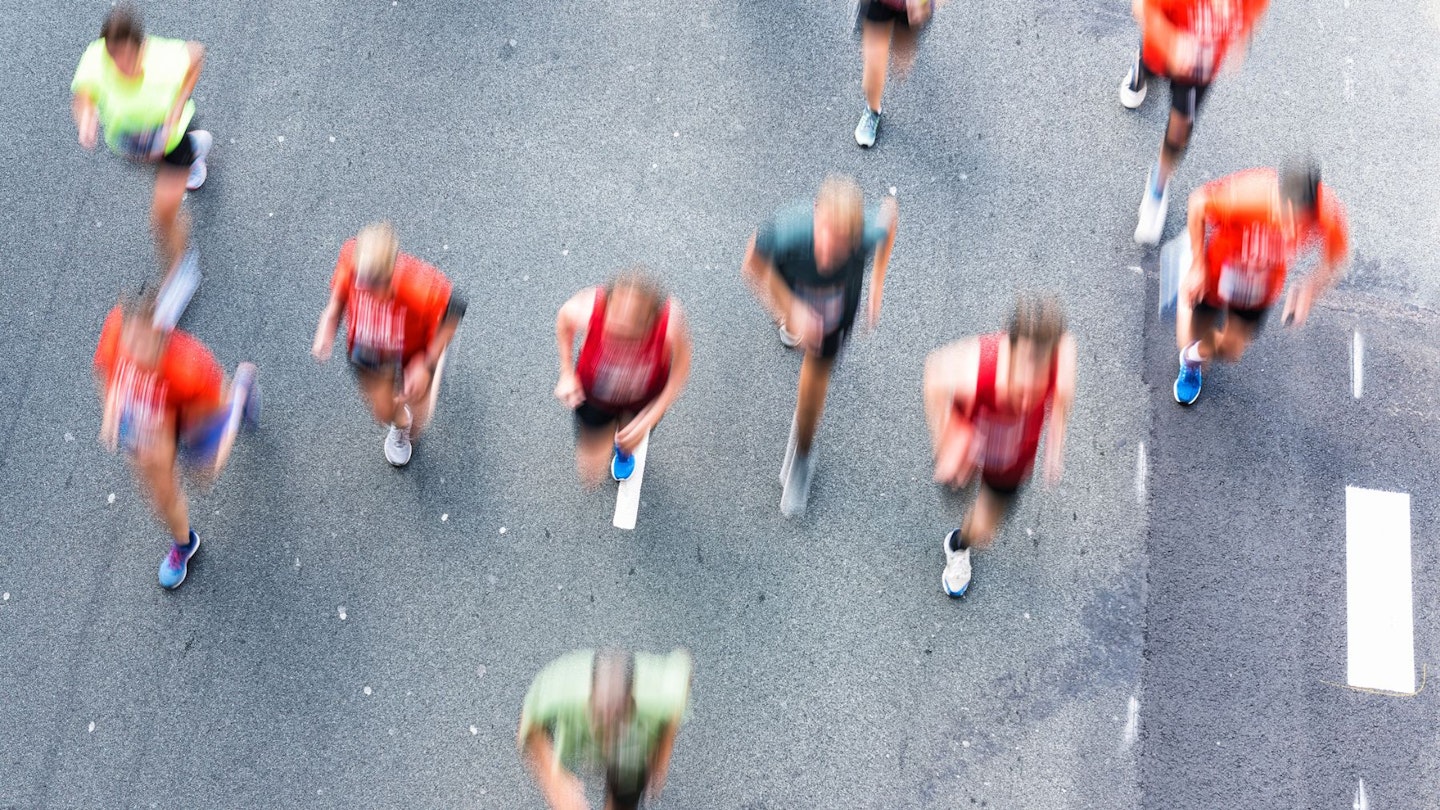 A group of runners completing a marathon - aerial view - they're going to need some post-run recovery