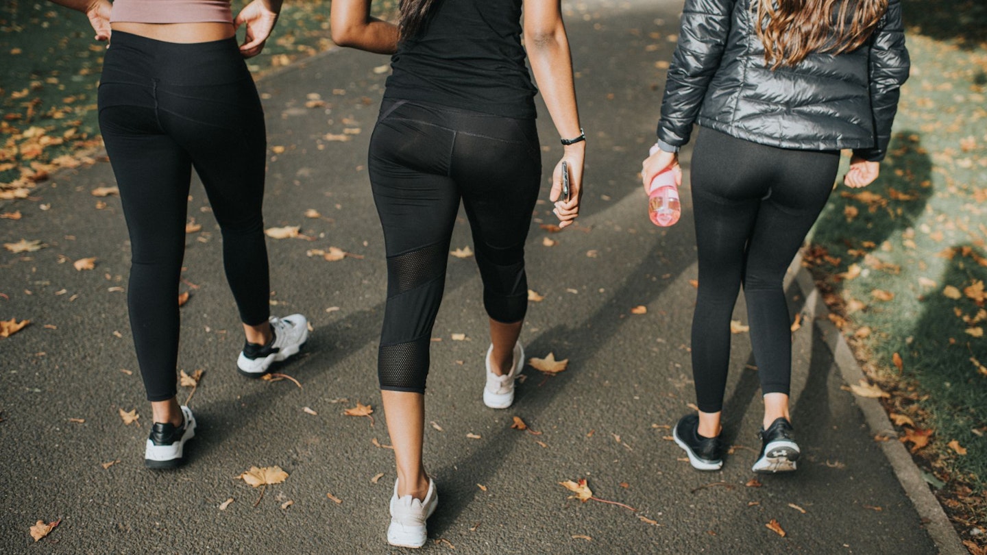 Three women on a walk, each wearing a pair of the best budget leggings