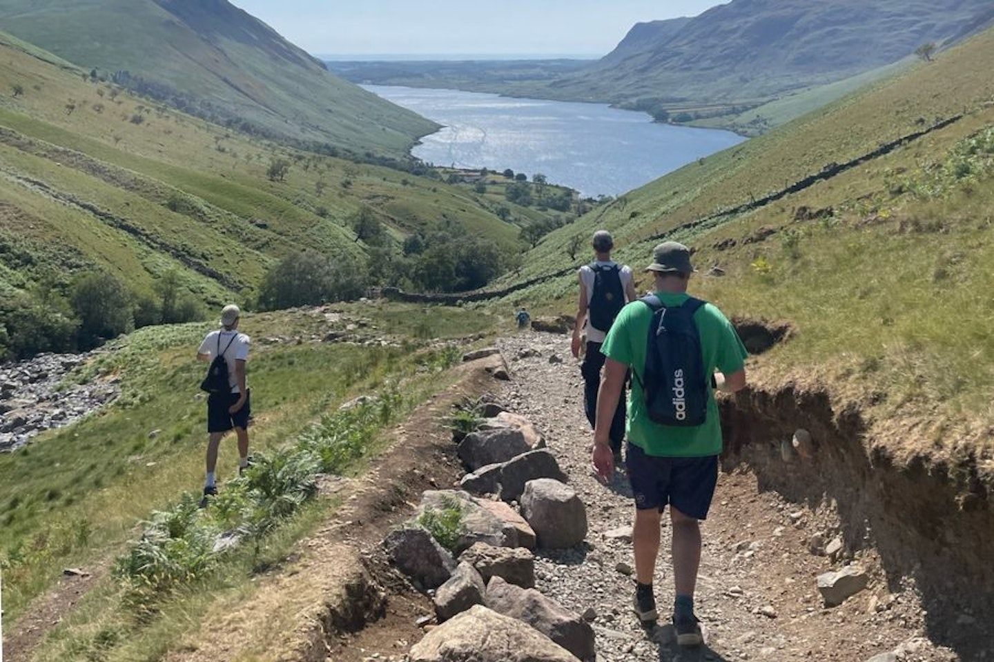 Three men walking down from Scafell Pike