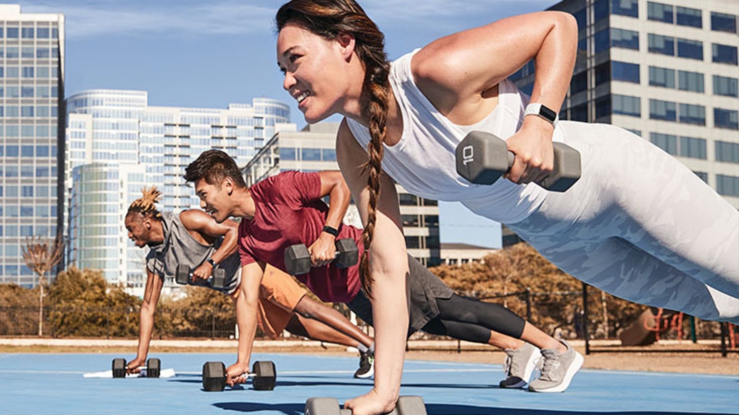 Three people doing circuit training outdoors in a city - how to get the most out of your Fitbit