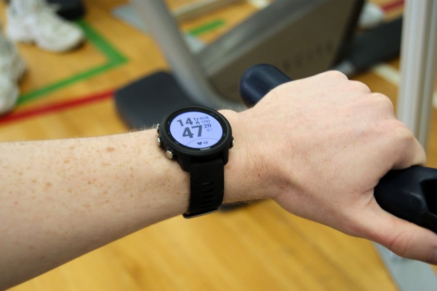 A person with a smartwatch in the gym