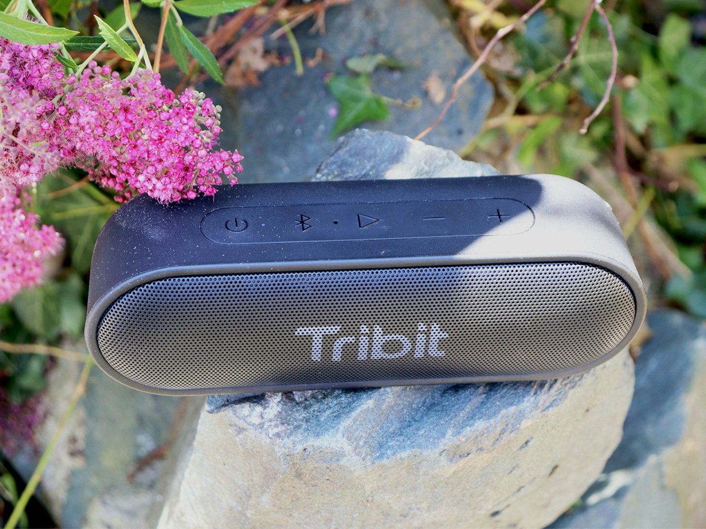 Tribit XSound Go portable wireless speaker in the garden