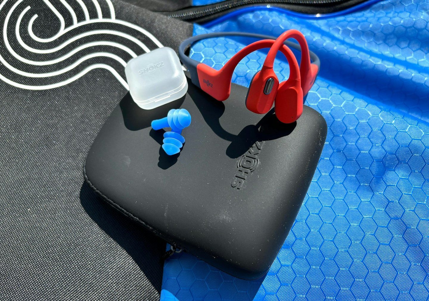 Shokz OpenSwim Pro case and earplugs