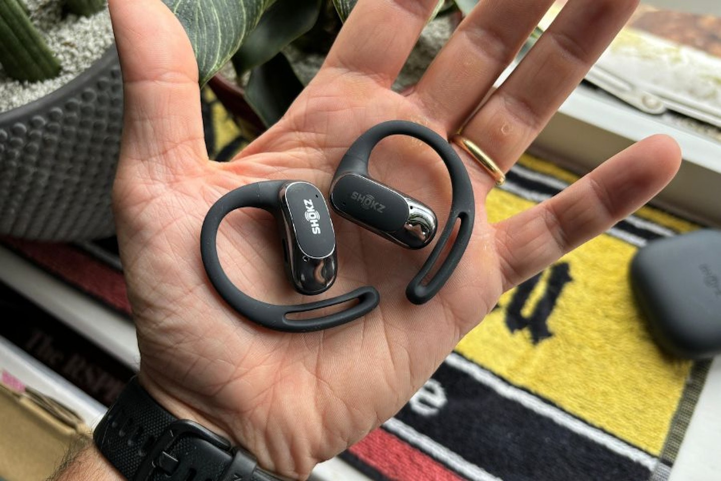 Shokz OpenFit Air Held In Hand