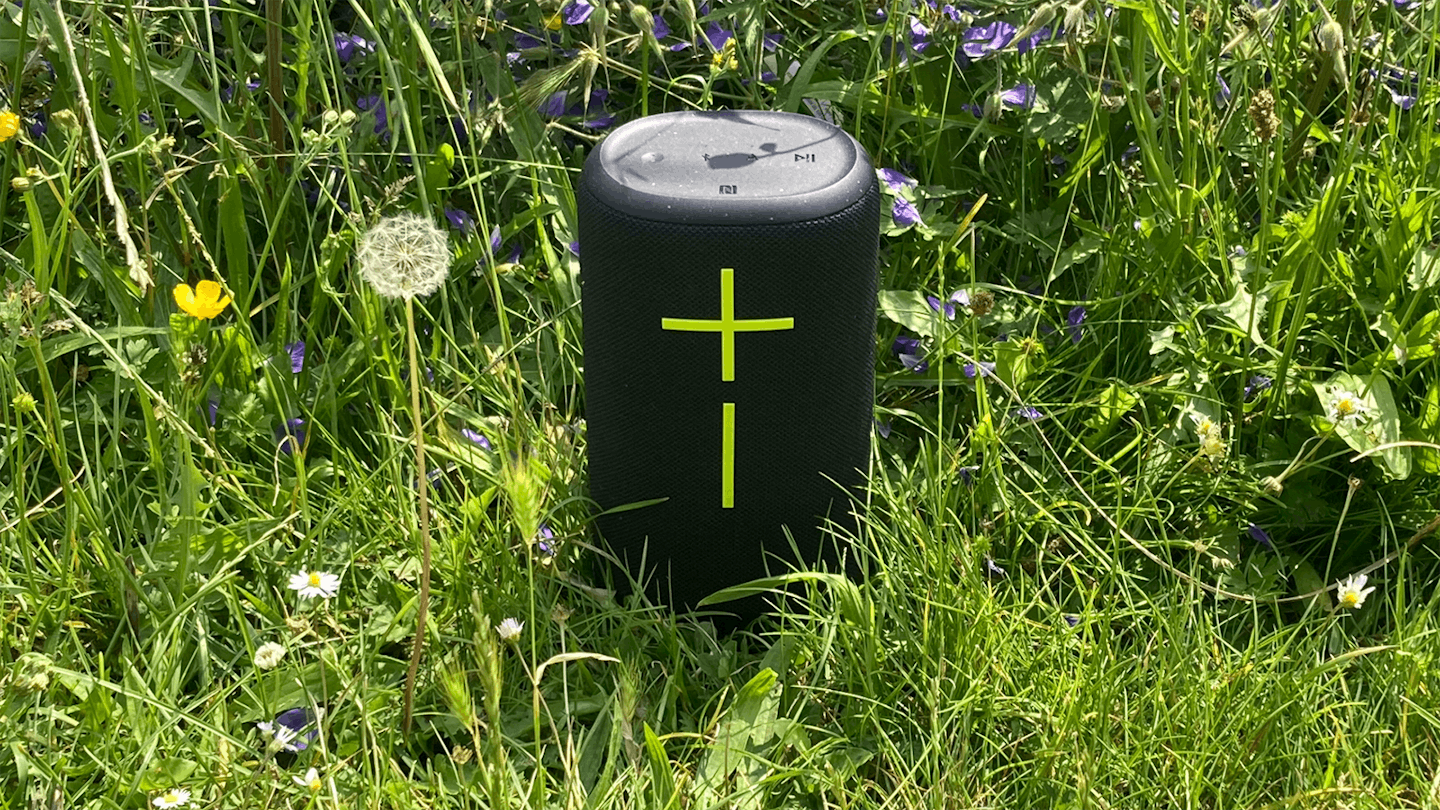 Ultimate-Ears-Everboom-speaker-outside-in-sunshine-among-flowers