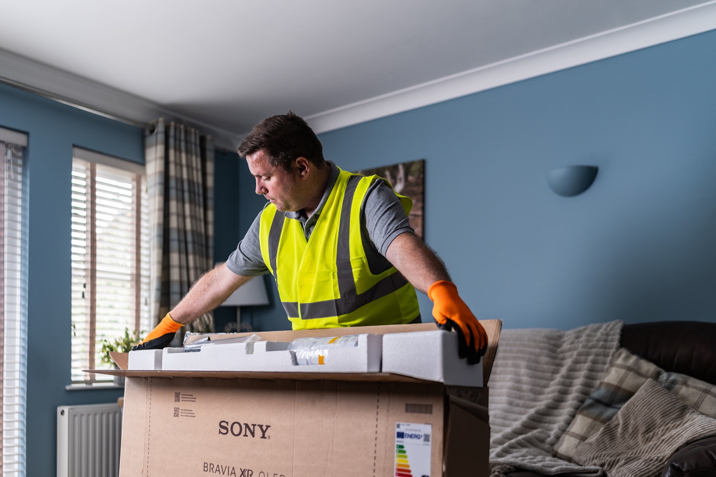 Man unpacking TV