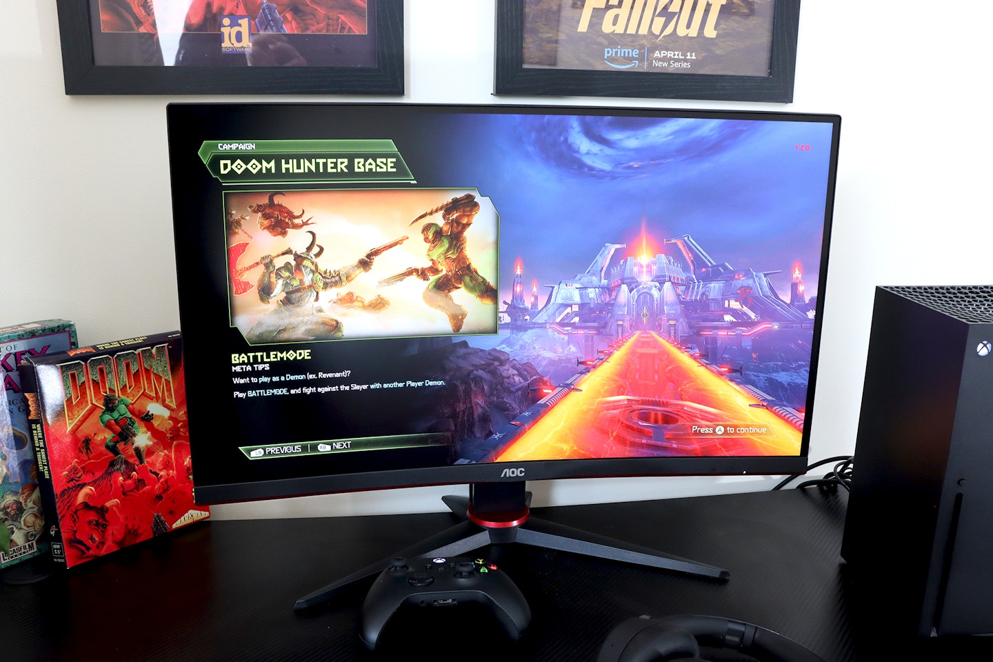 AOC Gaming CQ27G2SE monitor on a desk with an Xbox playing doom