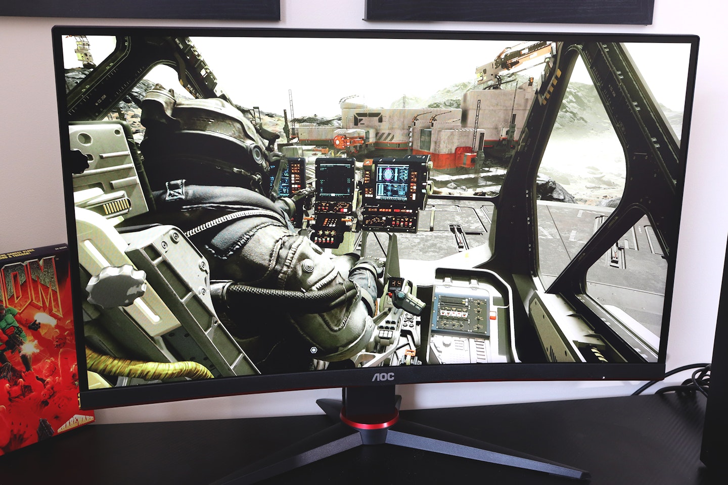 AOC Gaming CQ27G2SE monitor on a desk with an Xbox playing Starfield