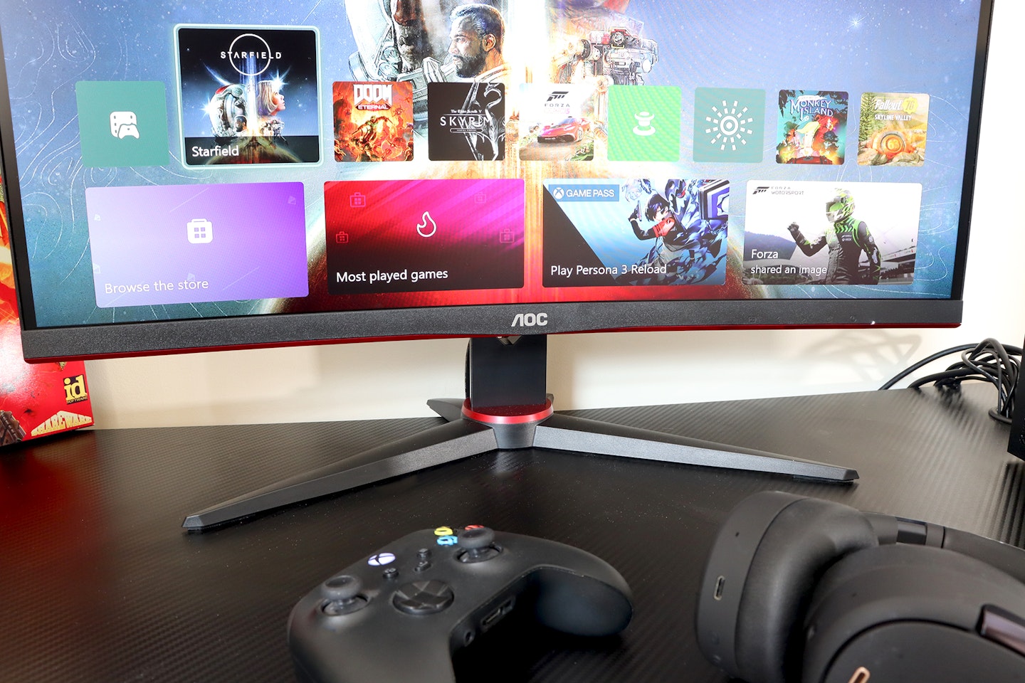 AOC Gaming CQ27G2SE monitor on a desk with an Xbox