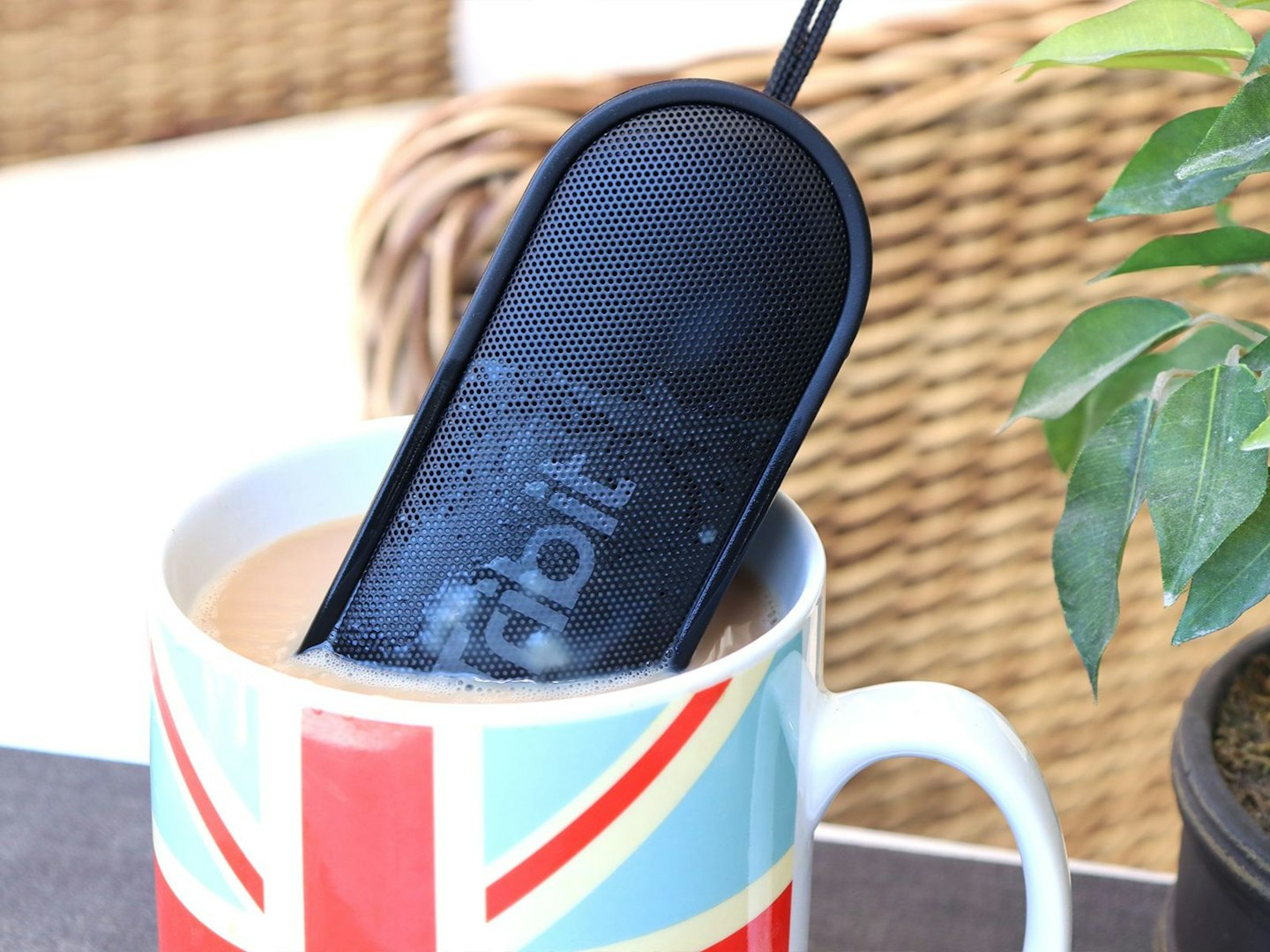 a waterproof speaker in a cup of tea