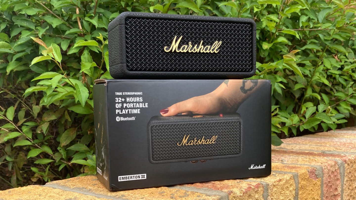 Marshall Emberton III speaker with box on wall in front of greenery. Marshall new Bluetooth portable speaker.