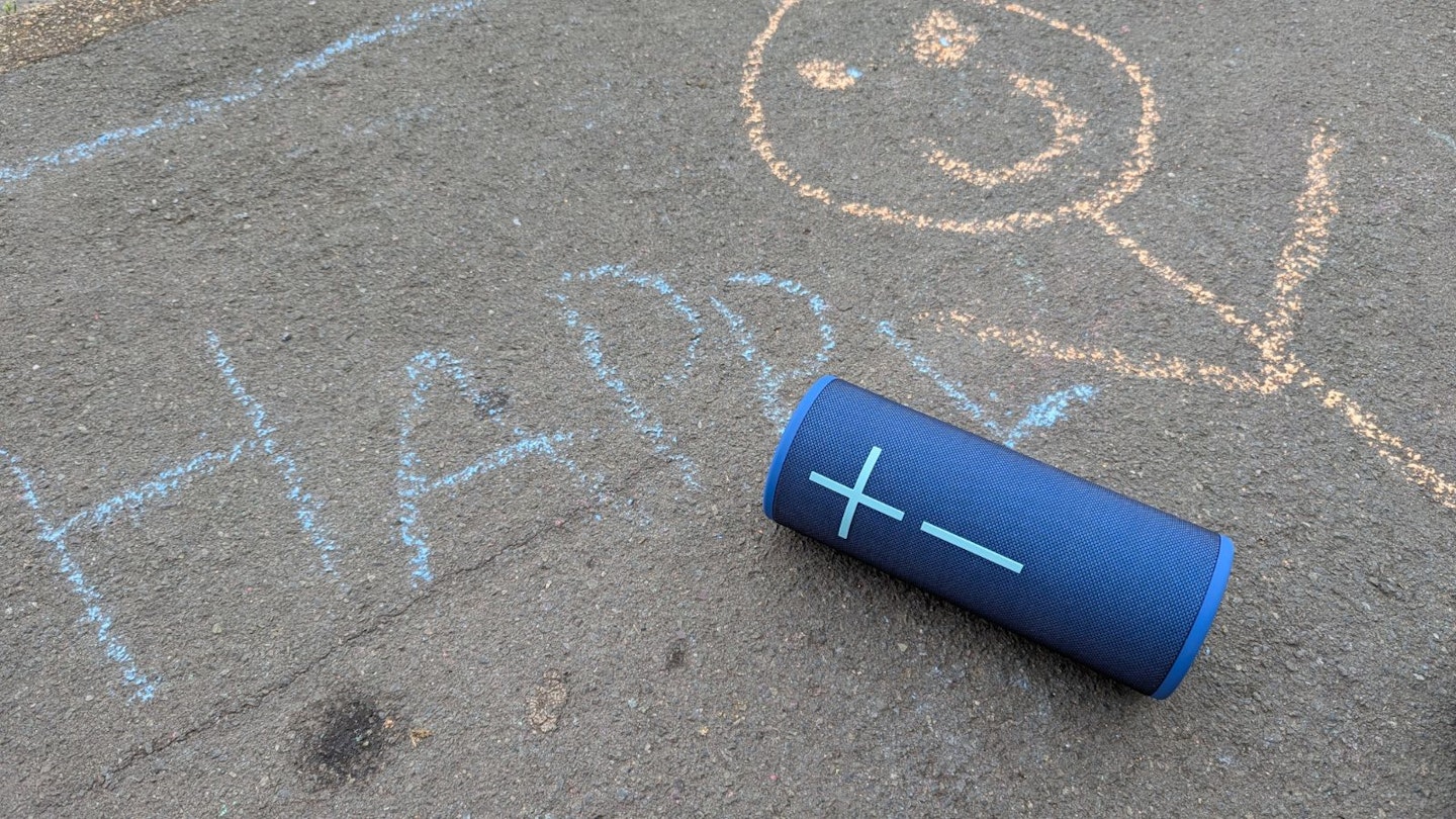 UE Boom 4 speaker next to chalk drawing on pavement