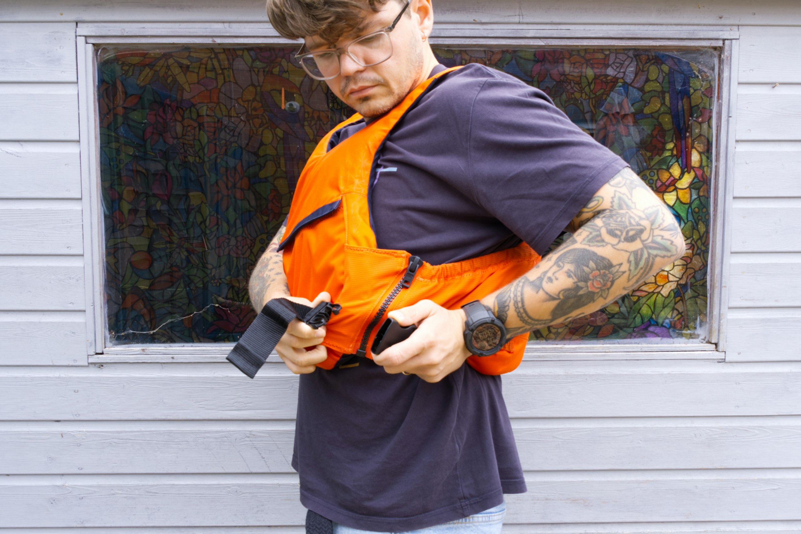 Trying on a buoyancy aid, with a side zip and clasp closure.