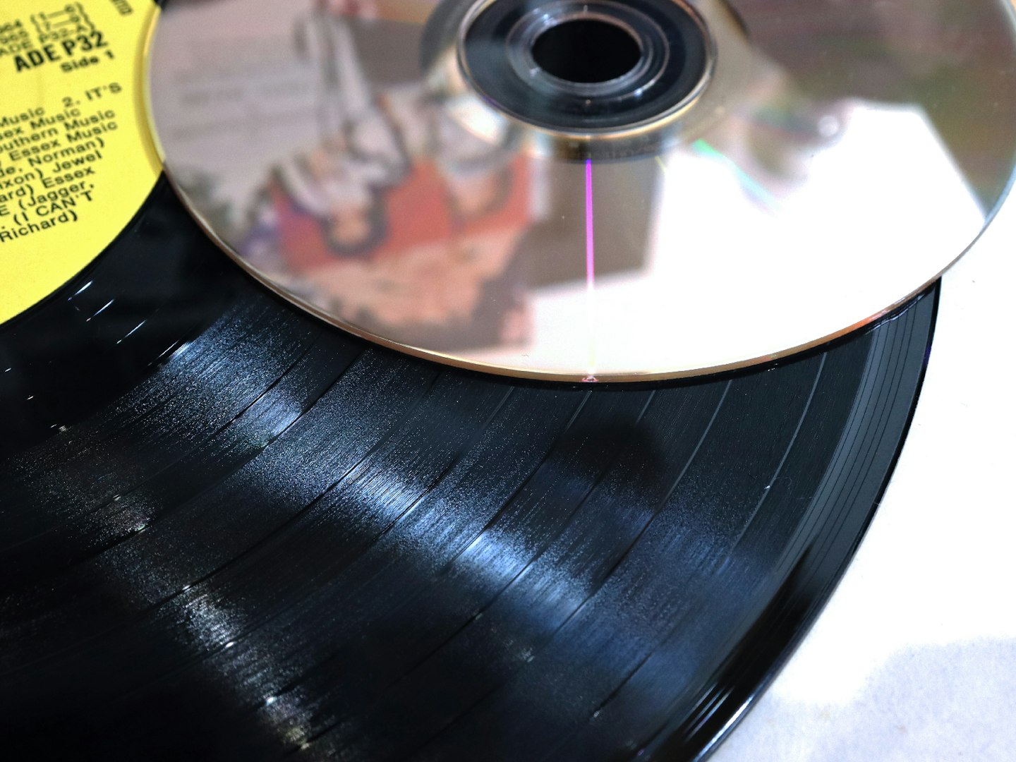 close up of a vinyl record and a CD