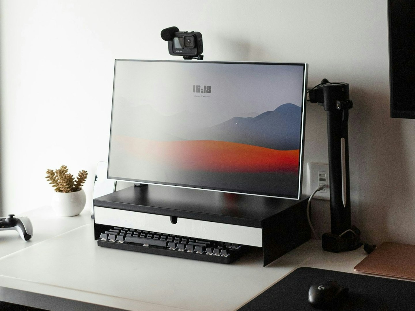 A desk with a laptop and monitor on it