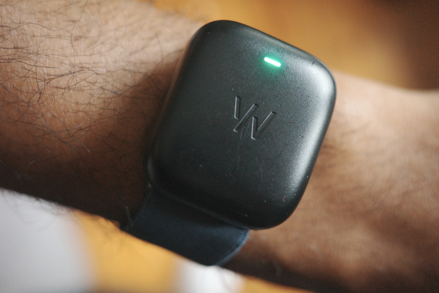 WHOOP charger being tested on a wrist