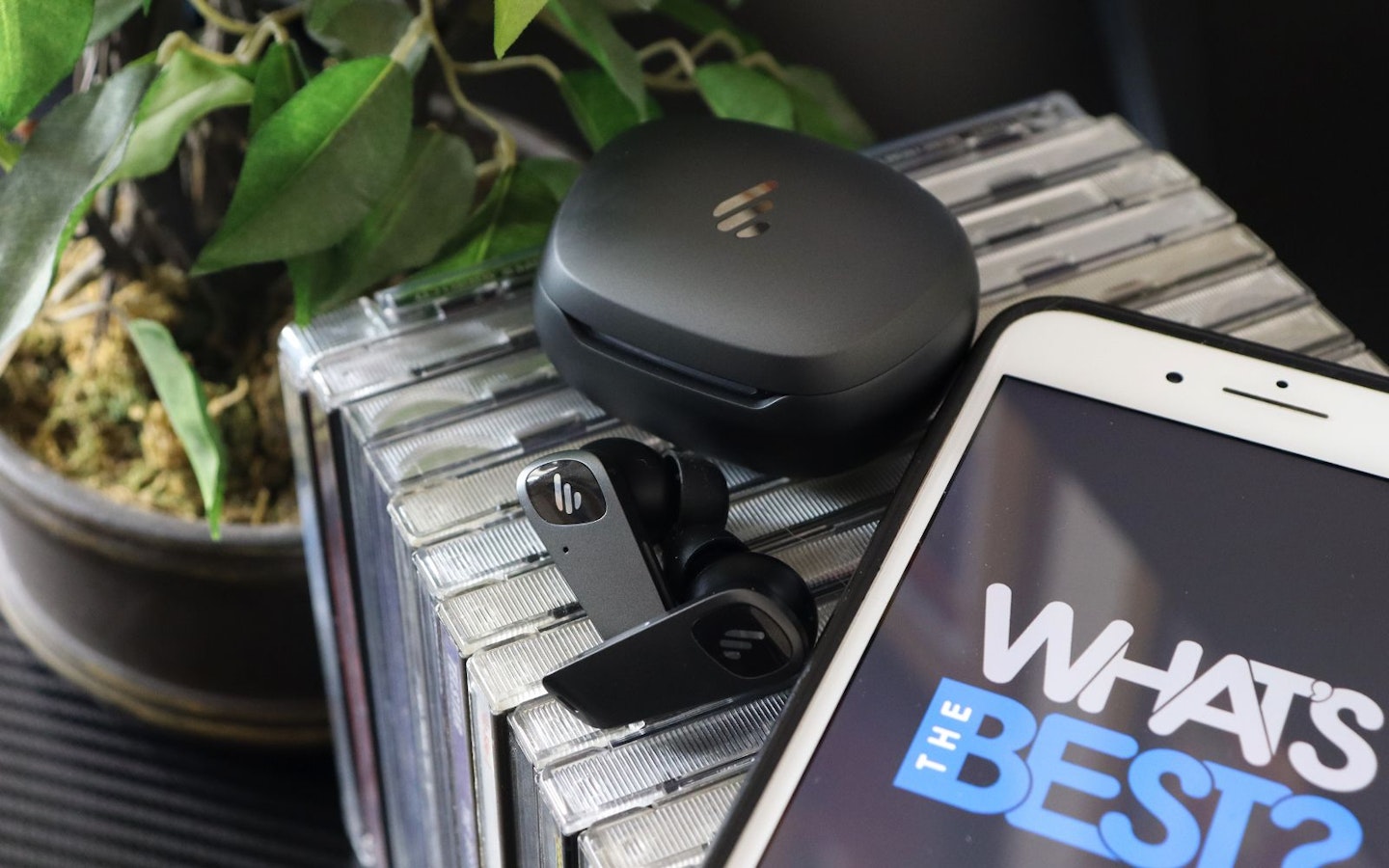 Edifier NeoBuds Planar earbuds and cds next to iphone with WTB logo