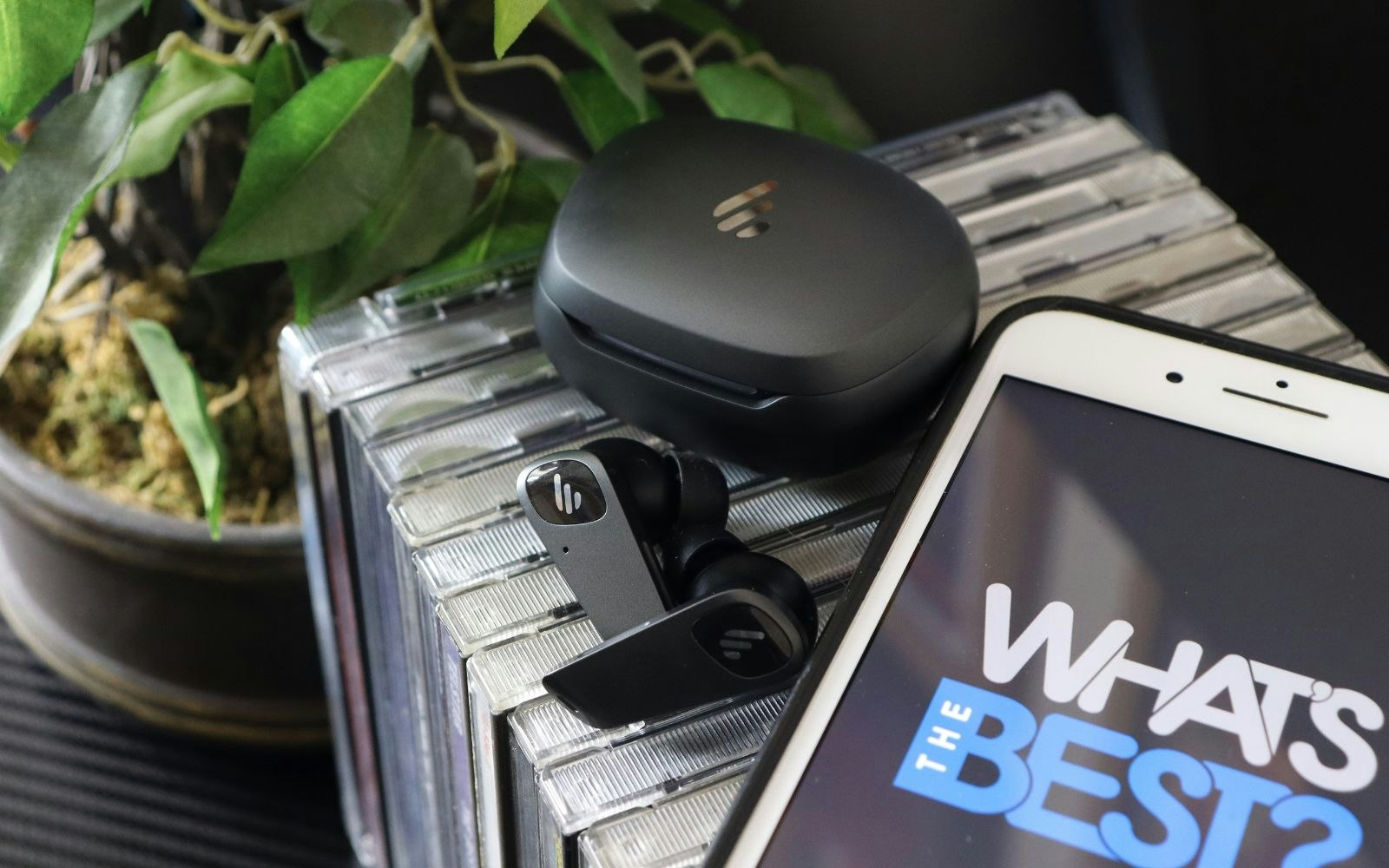 Edifier NeoBuds Planar earbuds and cds next to iphone with WTB logo