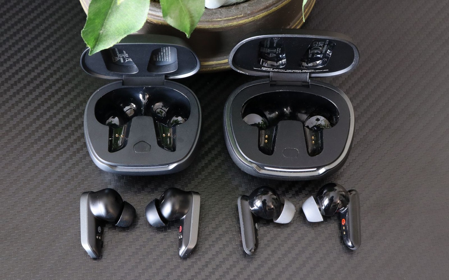 Edifier NeoBuds Planar earbuds and NeoBuds Pro 2 cases on a desk