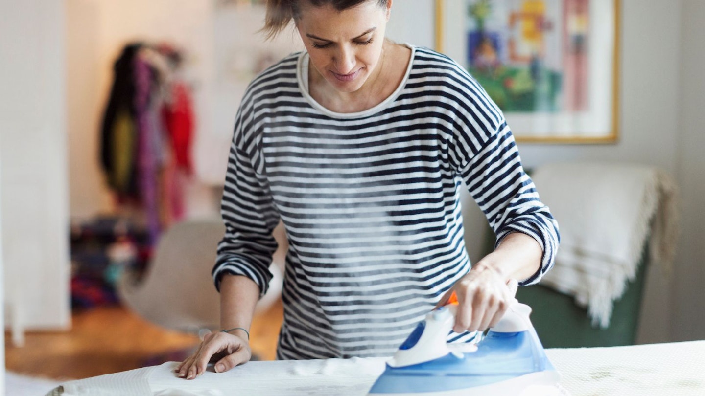 Woman using steam iron