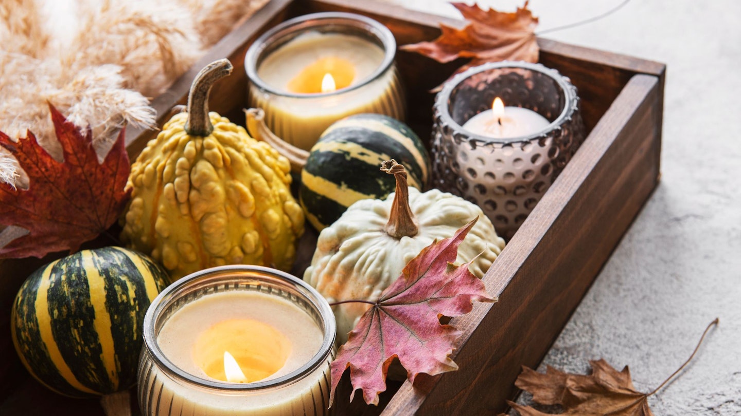 Autumn/Fall Composition With Multi Colour Pumpkins On Rustic Background with Candles