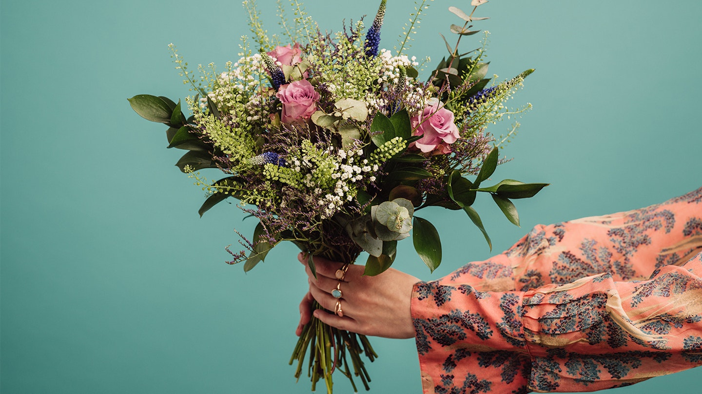 woman holding a bunch of flowers