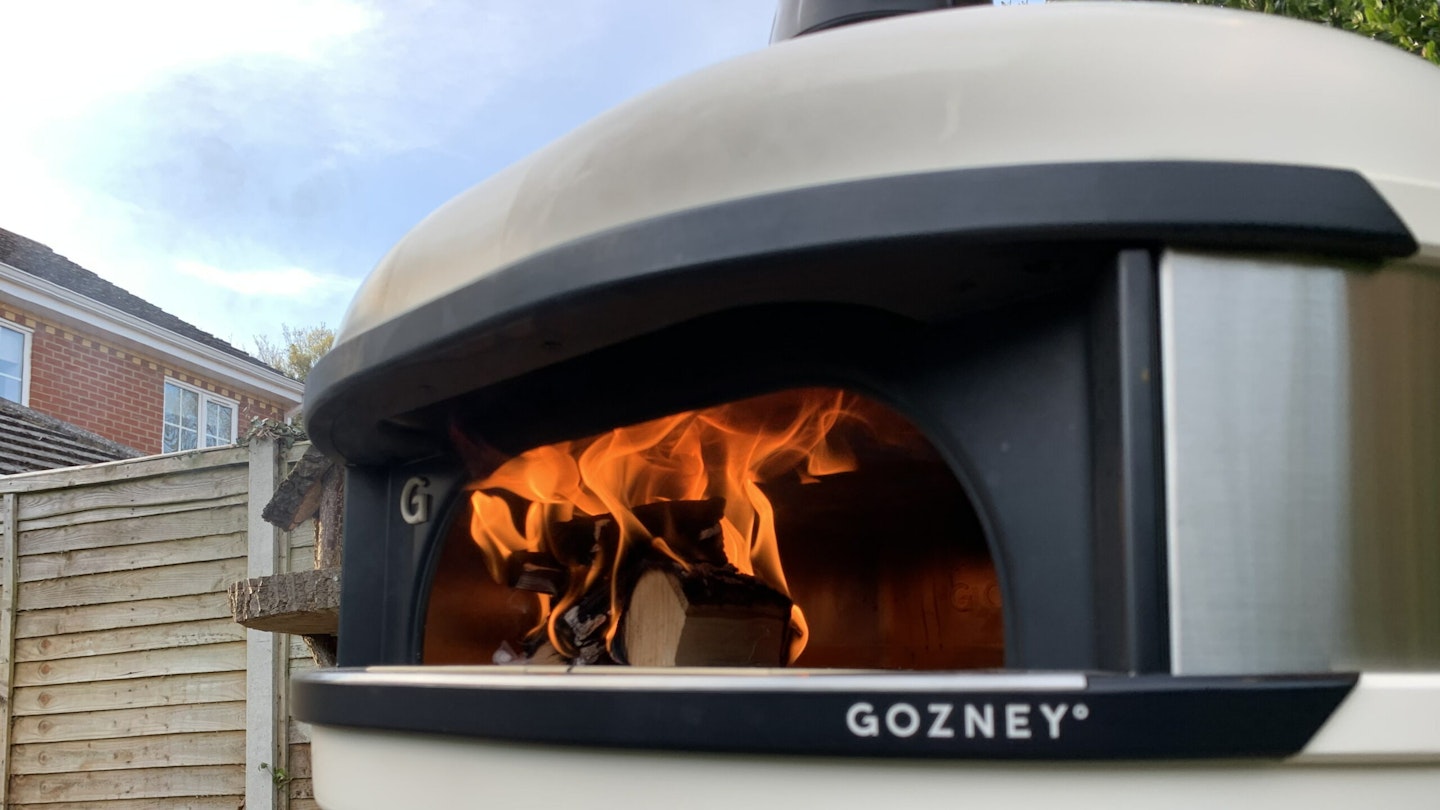 view of Gozney's Dome outdoor pizza oven being prepared with wood fire