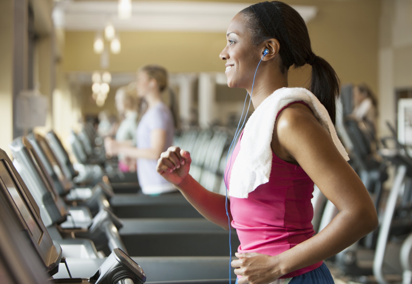 woman on treadmill listening to music