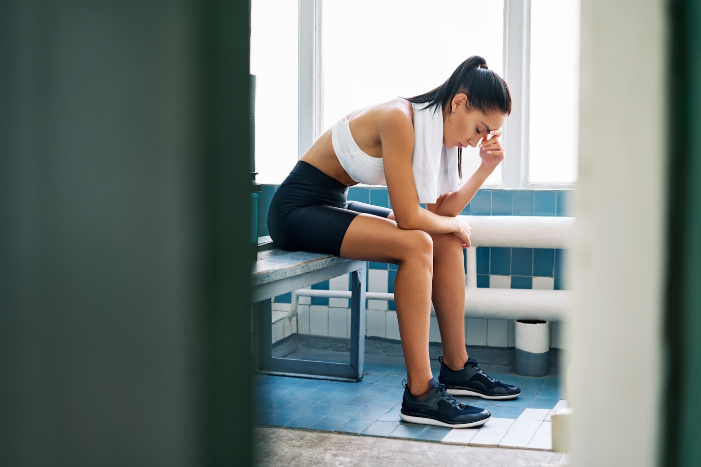 woman in changing room looking anxious