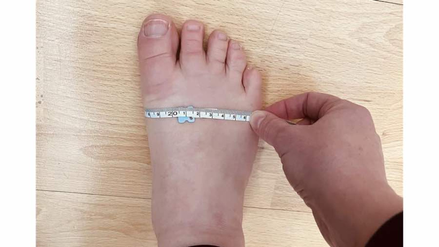 Right foot with tape measure around it