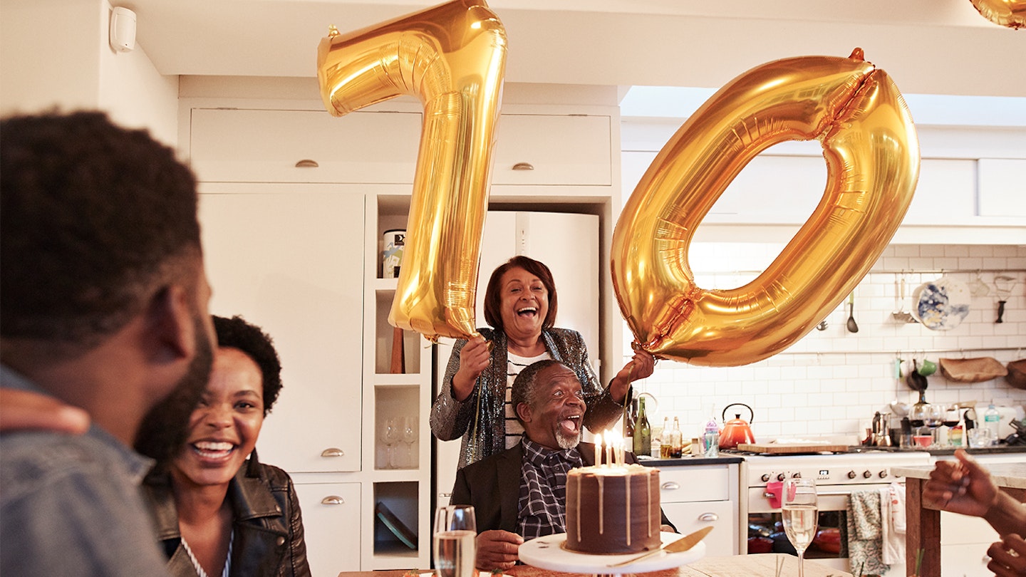 woman celebrating her 70th birthday with family