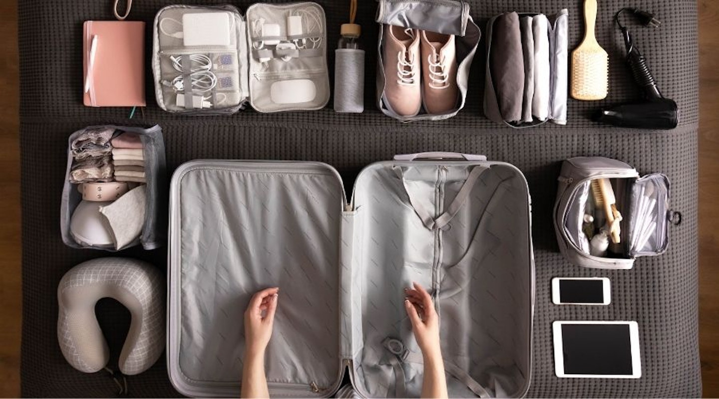 Packing cubes laid on a bed ready to be packed in a suitcase