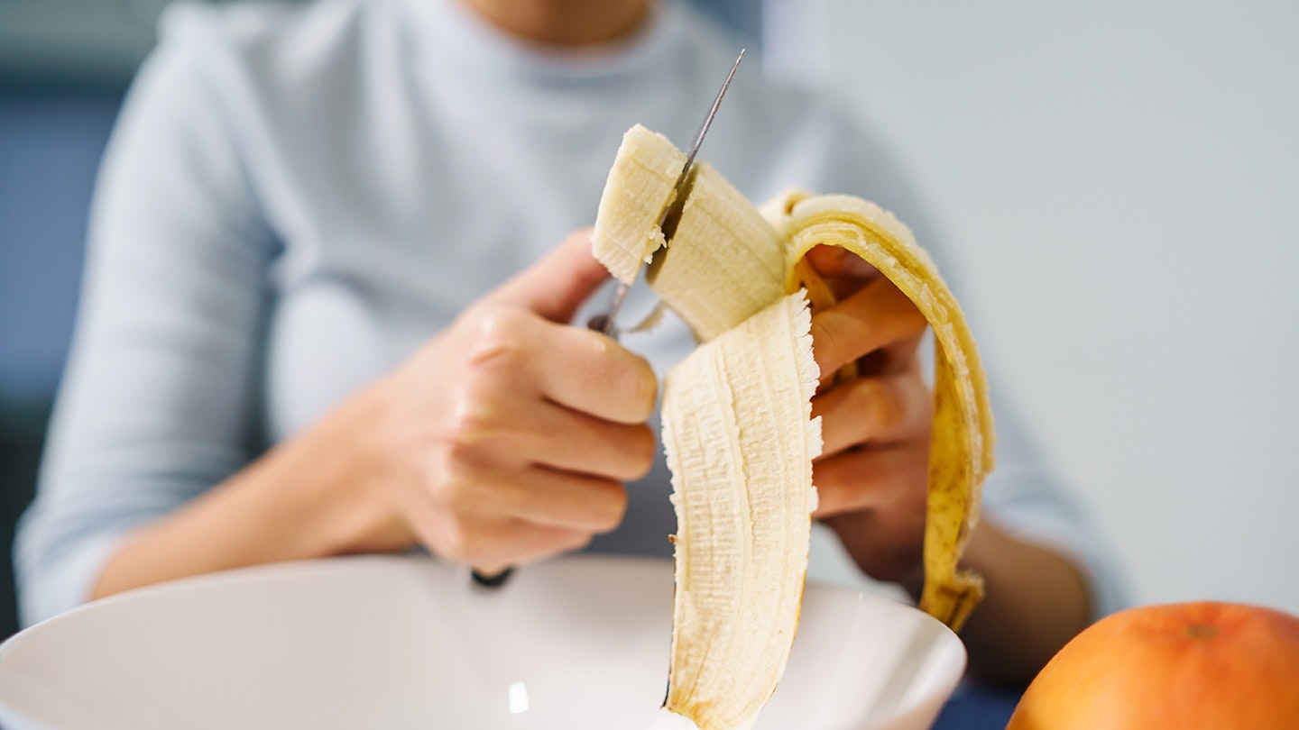 woman cutting banana